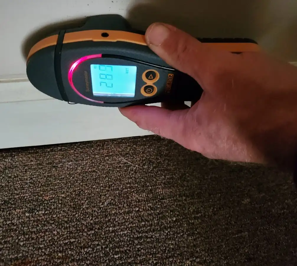 Moisture detection at baseboard during Storm Damage Restoration in Lower Windsor